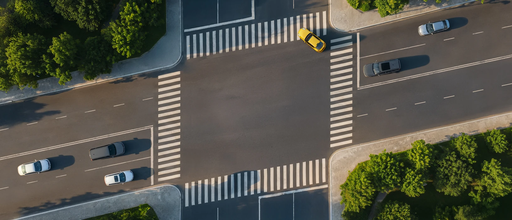 Aerial view of a street intersection where the crosswalks form a slanted parallelogram, imitating the Stripe logo.